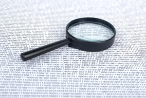 magnifying glass with binary code