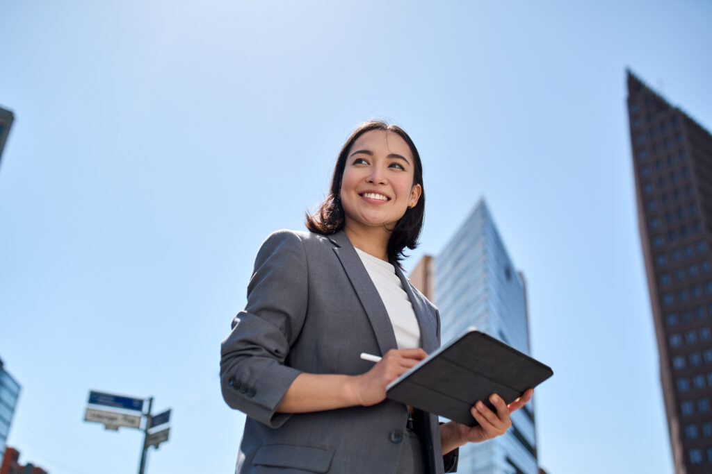 Vendia for Tech & Innovation teams. Woman with a tablet with city in the background