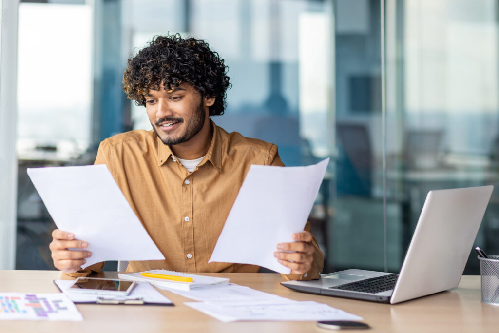 Vendia for Revenue Operations Teams - A man looking at different reports at his desk.